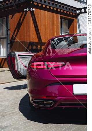Stylish luxury car parked outside modern building on sunny day Stylish luxury car parked outside modern building on sunny day 133570796