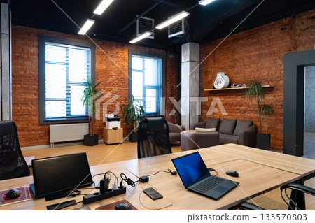Modern office space with brick walls and stylish furniture for a productive environment Modern office space with brick walls and stylish furniture for a productive environment 133570803