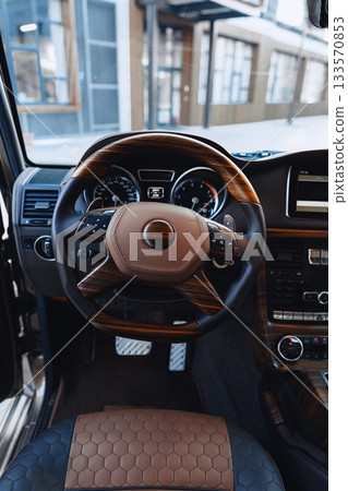 Luxury car interior with wooden accents and modern design in urban setting Luxury car interior with wooden accents and modern design in urban setting 133570853