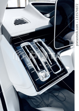 Modern car interior showcasing sleek climate control design and digital display 133570872