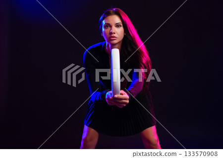 Woman posing with a lighting rod in a colorful studio environment for a creative photo shoot Woman posing with a lighting rod in a colorful studio environment for a creative photo shoot 133570908