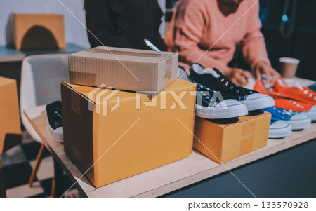 Asian woman describe selling clothes on camera live broadcast on social network at home, Online selling clothes on social media. Blogger woman influencer, SME retail store owner. 133570928