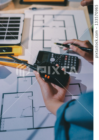 Architects and engineers working collaboratively on construction project 133570965