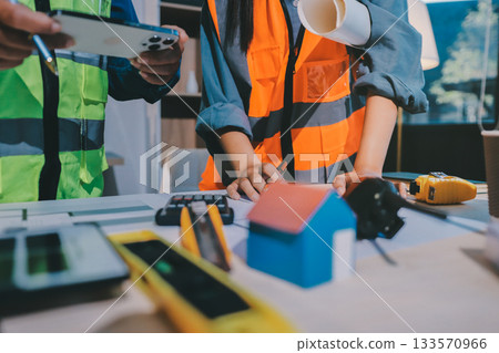 Architects and engineers working collaboratively on construction project Architects and engineers working collaboratively on construction project 133570966