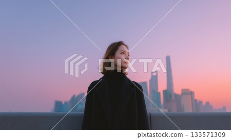 Young asian woman standing on a city rooftop, viewing modern urban skyline at sunset, contemplating the future possibilities and progress of contemporary life 133571309