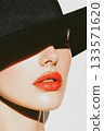 Sophisticated woman wearing wide brimmed black hat, black turtleneck, sporting bold red lipstick 133571620