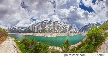 Panorama of Kolnbrein reservoir with dramatic clouds and snowy mountains Panorama of Kolnbrein reservoir with dramatic clouds and snowy mountains 133572085