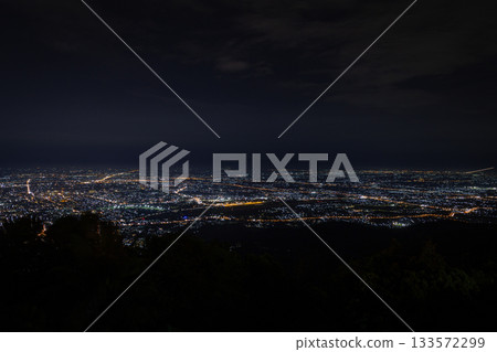Chiang Mai city lights at night from the mountains above the vast cityscape. 133572299