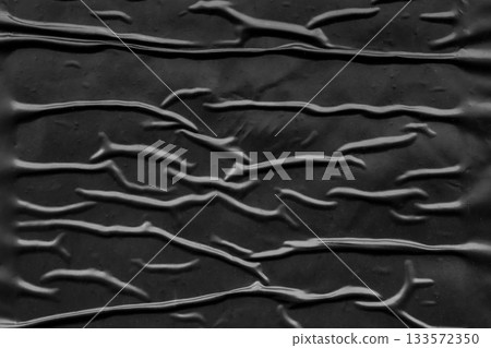 black crumpled and creased plastic poster texture background 133572350