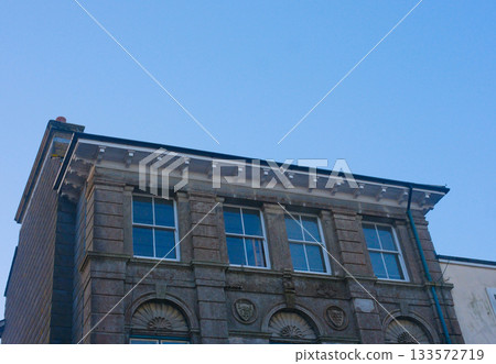 Looking up on a clear sky at the roof-tops and differences Looking up on a clear sky at the roof-tops and differences 133572719