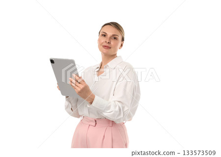Confident woman in white blouse with tablet, isolated on white, PNG 133573509