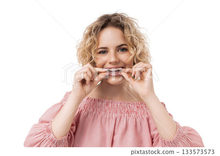 Woman is applying clear aligners to straighten teeth, isolated, PNG 133573573