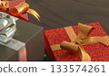 Christmas Gifts and Mini Wreath on Wooden Table 3d render. 133574261