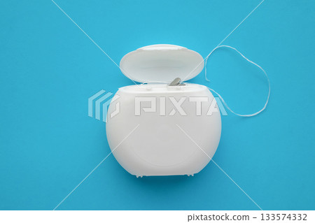 dental floss in case on blue background dental floss in case on blue background 133574332