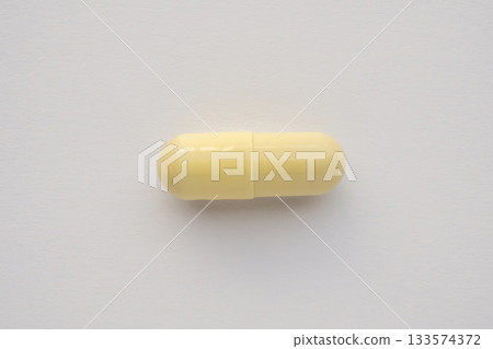 Yellow medicine vitamin pill capsule on white background 133574372