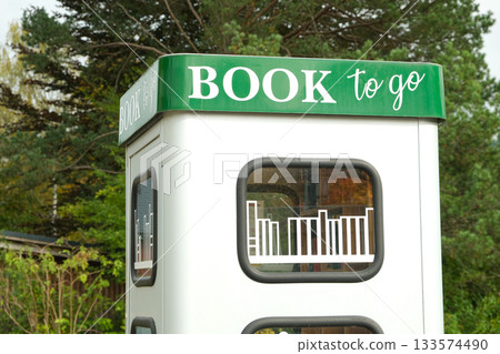 Book to go. Public street book-sharing kiosk with free community books for readers Book to go. Public street book-sharing kiosk with free community books for readers 133574490