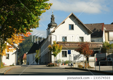 A small European town with a traditional look and a church 133574503