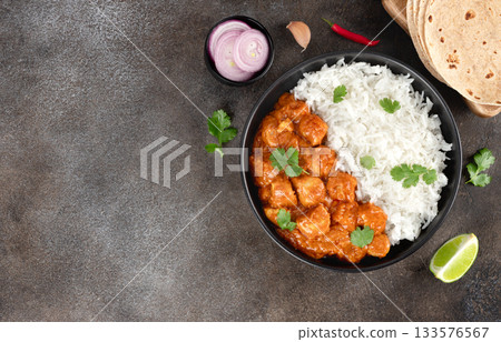 Traditional Indian chicken tikka masala with basmati rice, naan bread on gray background. Top view. Copy space. 133576567