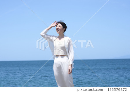 A woman relaxing on the coast A woman relaxing on the coast 133576872