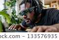 Blind employee using a braille keyboard and screen reader headset in bright coworking space 133576935