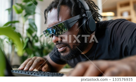 Blind employee using a braille keyboard and screen reader headset in bright coworking space Blind employee using a braille keyboard and screen reader headset in bright coworking space 133576935