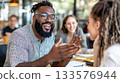 Black man in casual-smart attire speaking confidently in a strategy meeting with a white female colleague 133576944