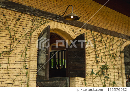Open barn doors reveal a well-maintained rustic structure 133576982