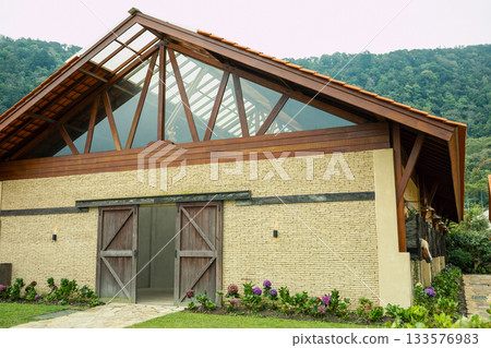 Rustic structure with large windows and wooden details 133576983
