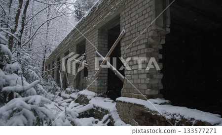 War Ukraine long brick corridor with snow outside, series of window openings framed by wooden braces, deep interior shadows and perspective lines, cold damp atmosphere, composition fit 133577271
