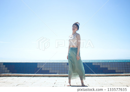 A woman relaxing on the coast 133577635