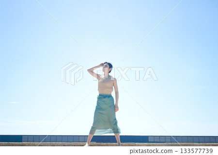 A woman relaxing on the coast A woman relaxing on the coast 133577739