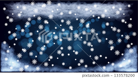Snowflakes falling softly against a dark blue background with a hint of mist and clouds during a winter evening 133578200