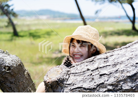 A girl playing under a tree A girl playing under a tree 133578403