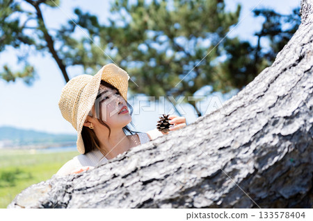 A girl playing under a tree A girl playing under a tree 133578404