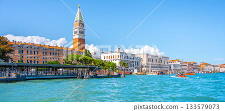 Venice historical center waterfront. Landmarks around St Mark Square with St Mark Campanile and Doge Palace. Sunny summer day in Venice, Italy. 133579073