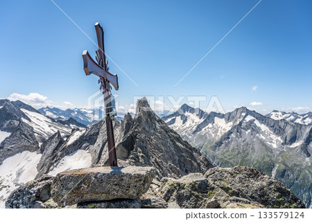 Summit metal cross on the top of Richterspitze Mountain, Zillertal Alps, Austria Summit metal cross on the top of Richterspitze Mountain, Zillertal Alps, Austria 133579124
