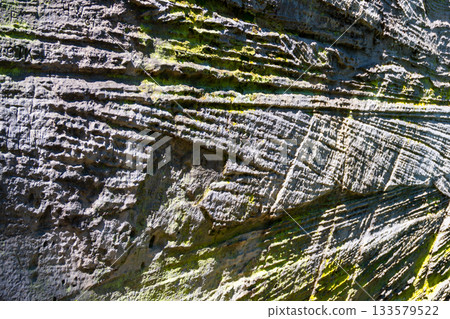 Visitors explore the striking sandstone formations at Prihrazy Rocks in Bohemian Paradise, showcasing unique textures and patterns created by nature's erosion over time. 133579522