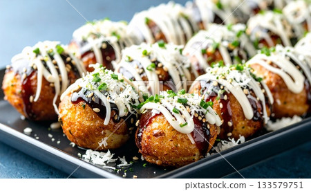 Close-up of Delicious Takoyaki Balls Topped with Garnishes 133579751