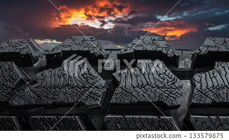 Dramatic Sunset Seen Through Deep Tire Treads 133579875