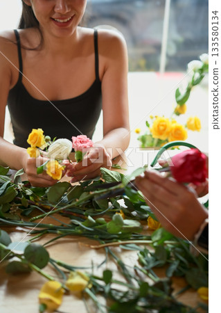Closeup enjoyment young woman florist arranging plants 133580134