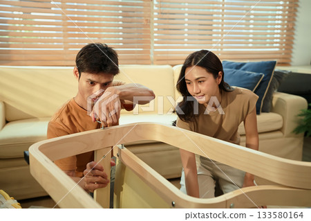 Photo series of young asian couple assembly a new furniture at home Photo series of young asian couple assembly a new furniture at home 133580164