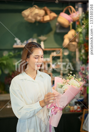 Florist woman selects flowers for making bouquet 133580168