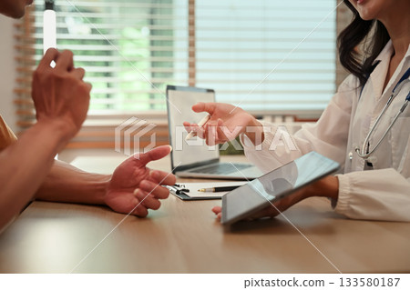 Closeup medical consult with tablet Closeup medical consult with tablet 133580187