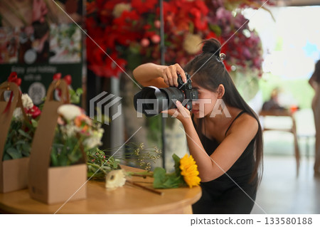 Florist woman photographing her flower products in the shop 133580188