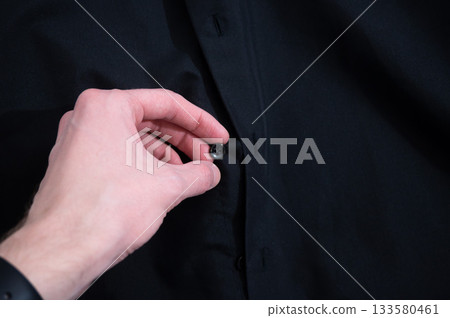 Black shirt hanging on hange 133580461