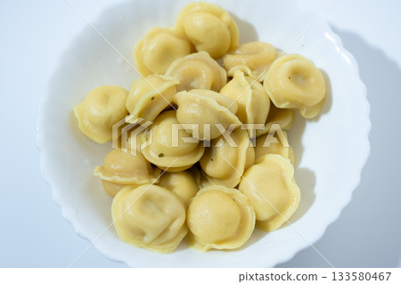 Dumplings in White Plate on Light Blue Background 133580467