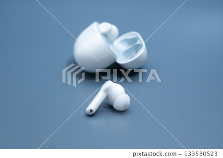 White wireless earbuds charging case open 133580523