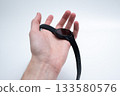 Black Smartwatch on Wrist in Relaxed Pose 133580576