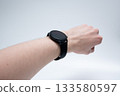 Black Smartwatch on Wrist in Relaxed Pose 133580597