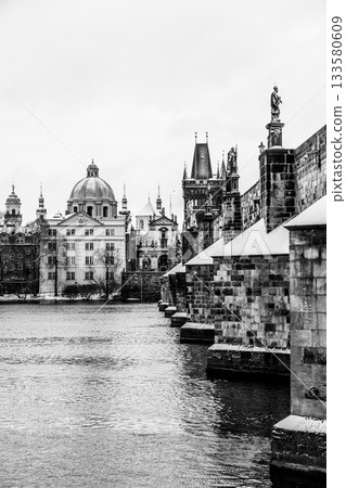 Historical Charles Bridge, Czech: Karluv most, over Vltava River in winter. Prague, Czech Republic. Black and white image. Historical Charles Bridge, Czech: Karluv most, over Vltava River in winter. Prague, Czech Republic. Black and white image. 133580609